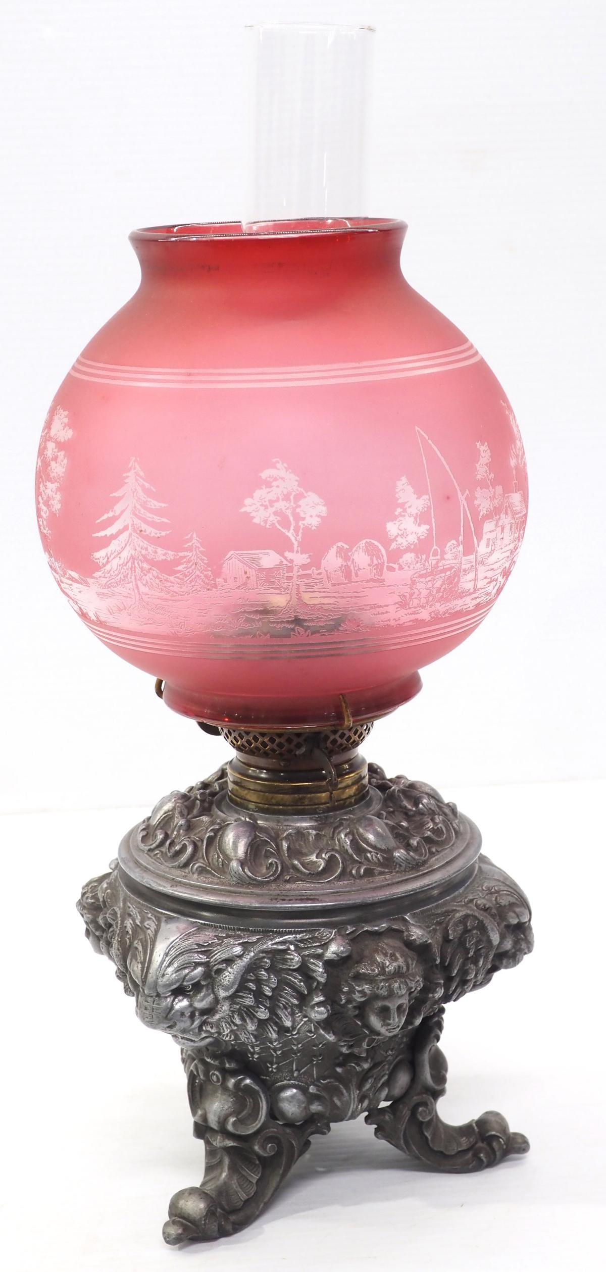 Kerosene lamp with pewter base: Kerosene lamp with pewter base and pink decorative shade, 19"H * * Not eligible for in-house shipping, white glove options may be available. See auction terms.
