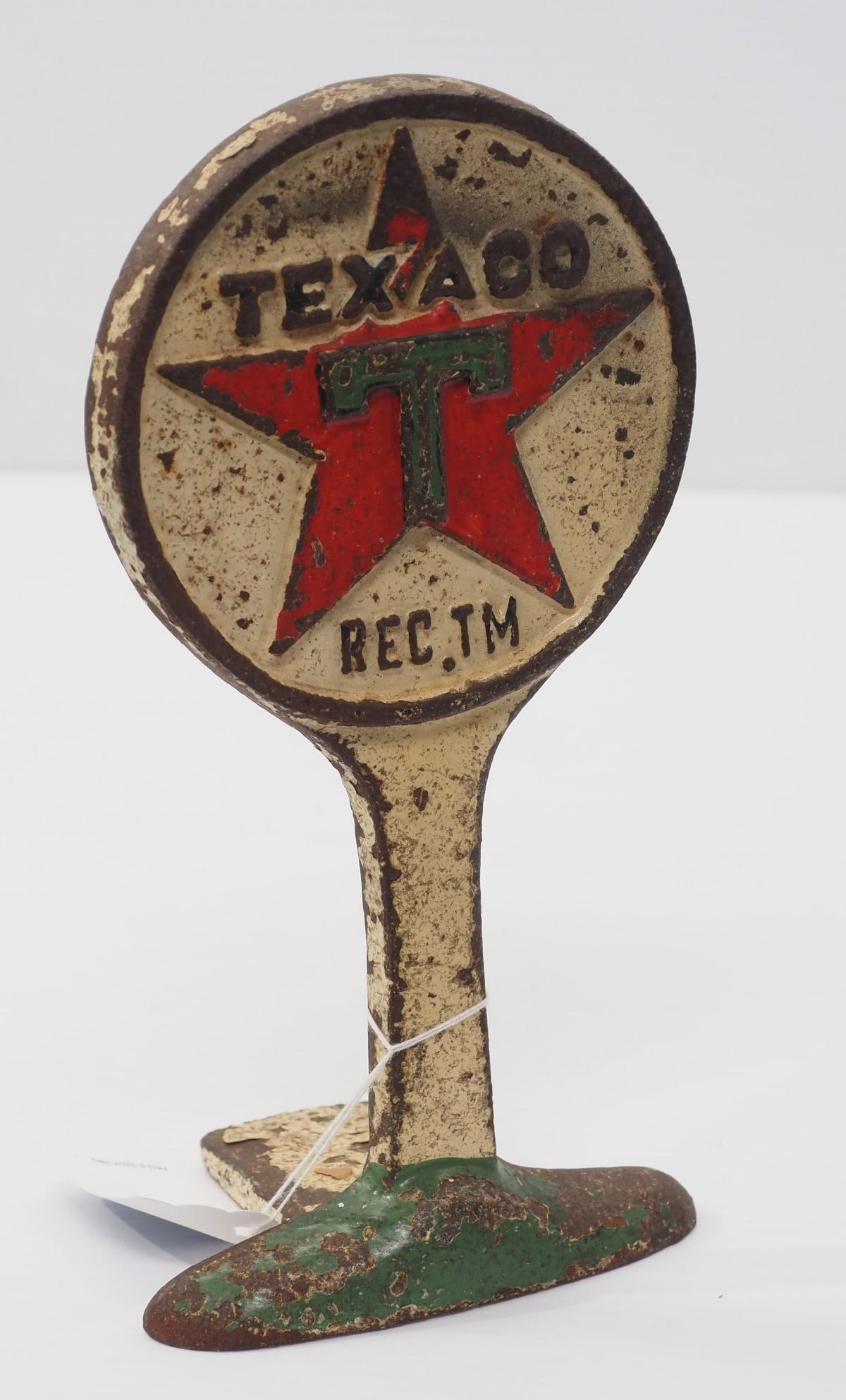 Cast iron Texaco doorstop: Cast iron Texaco doorstop with some original color and dated 1927?, 5"W x 10"H - Good with paint wear and a fold at side