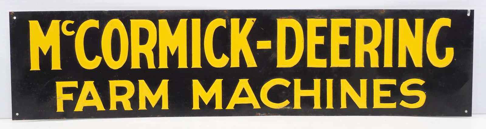 McCormick-Deering Farm Machines sign: 23.5"x5.5" SST embossed McCormick-Deering Farm Machines sign - Good