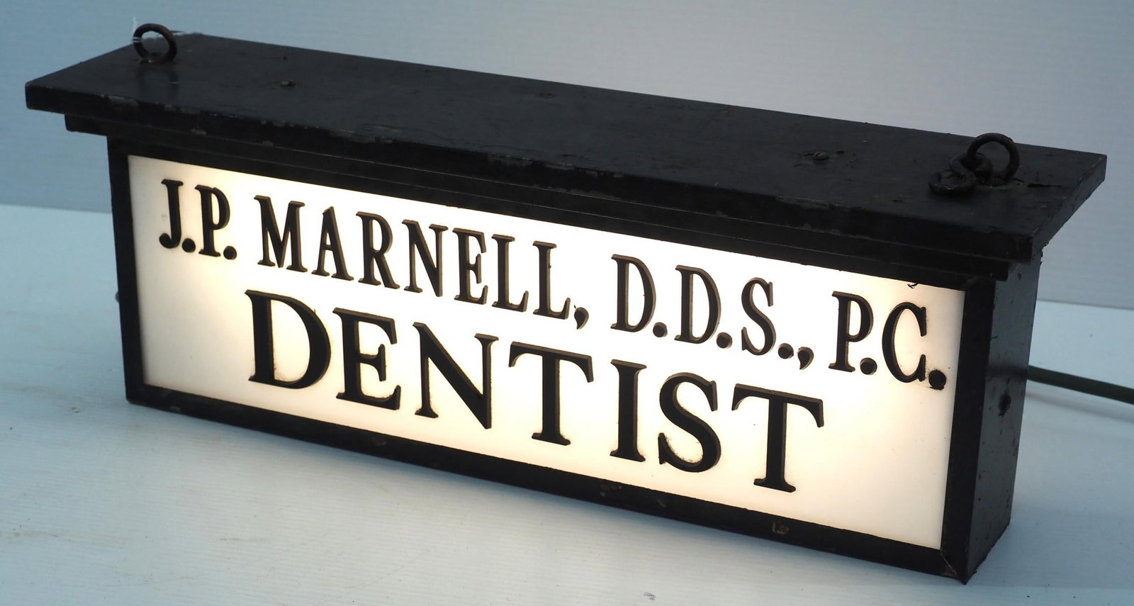 Light-up sign for J.P. Marnell DDS PC, Dentist: 21"x7.5" metal-framed, light-up trade sign with plastic panels for J.P. Marnell DDS PC, Dentist - Good, works