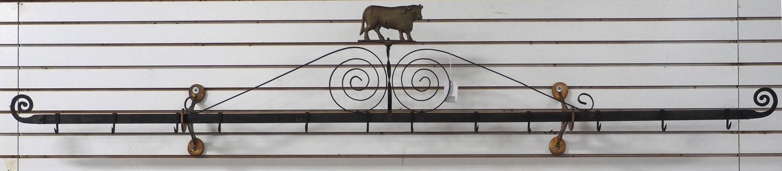 Heavy cast iron, wall-mount meat rack: Heavy cast iron, wall-mount meat rack with brass brackets and cow topper plus lots of hooks, 8'L * * Item(s) not eligible for shipping, contact Chupp Auctions for driver recommendations. Must be