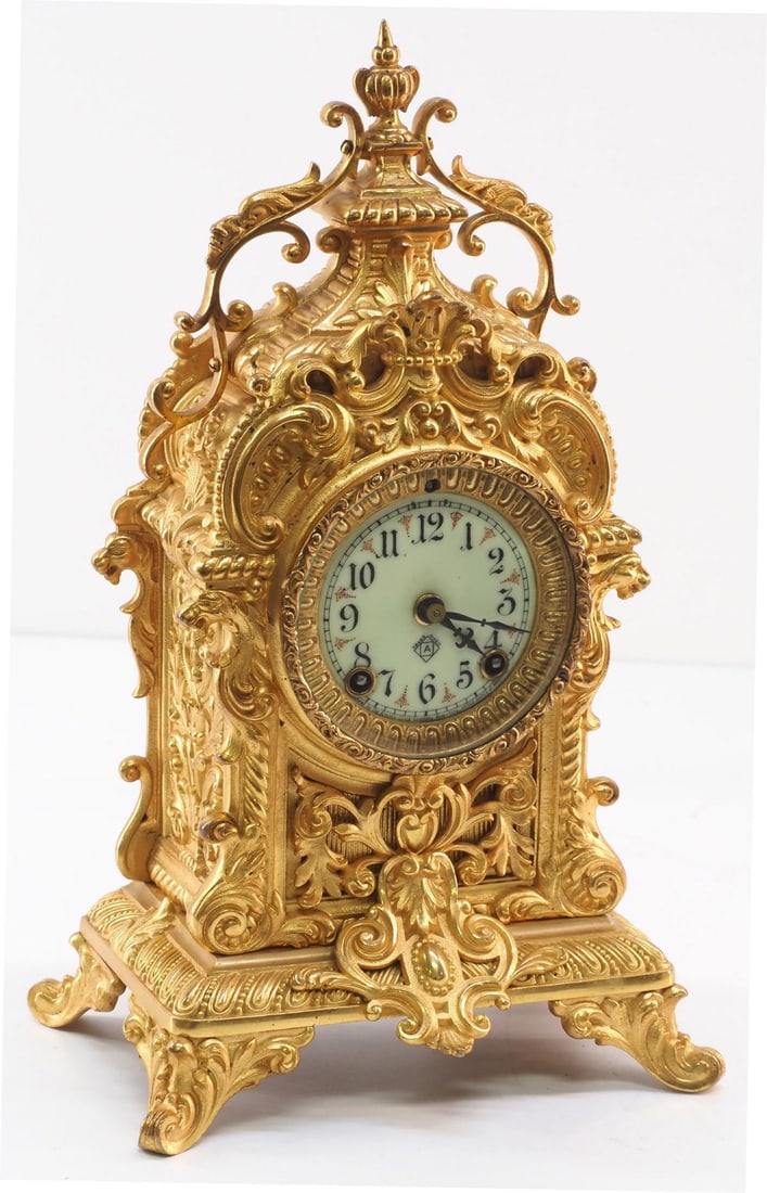 Ansonia Rococo-style Gold Gilt Shelf Clock with Cathedral Gong: Ansonia Rococo-Style Gold Gilt Shelf Clock with Cathedral Gong, Porcelain Dual Winding Dial and Ansonia Stamp - missing back door Condition NOTICE! VERY IMPORTANT! Chupp Auctions is pleased to issue a
