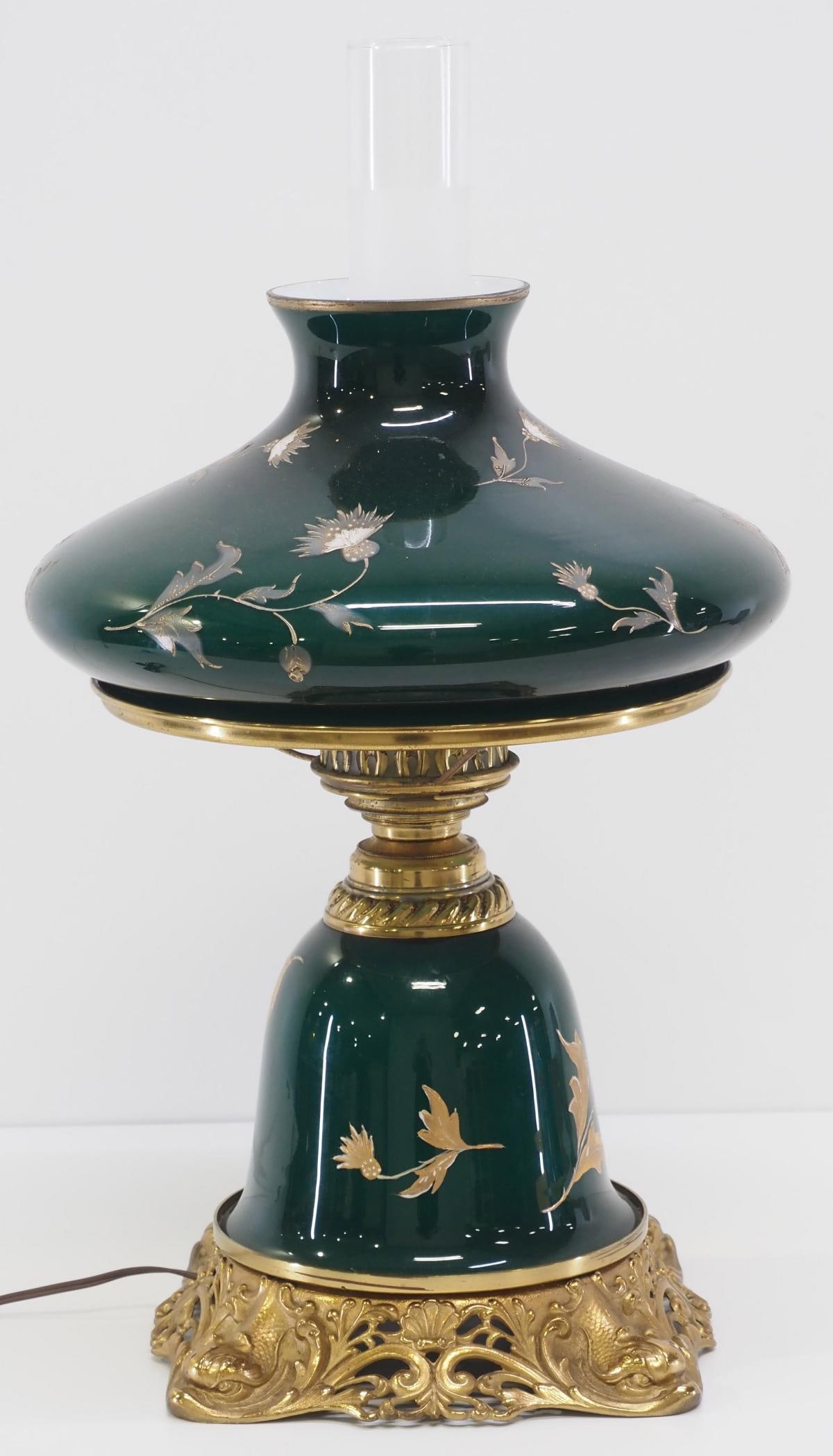 Emerald Art Nouveau Table Lamp: Emerald Art Nouveau Table Lamp with Gold Thistle Overlay, Matching Shade and Font with Dolphin Face Base Condition NOTICE! VERY IMPORTANT! Chupp Auctions is pleased to issue an opinion on any lot; the