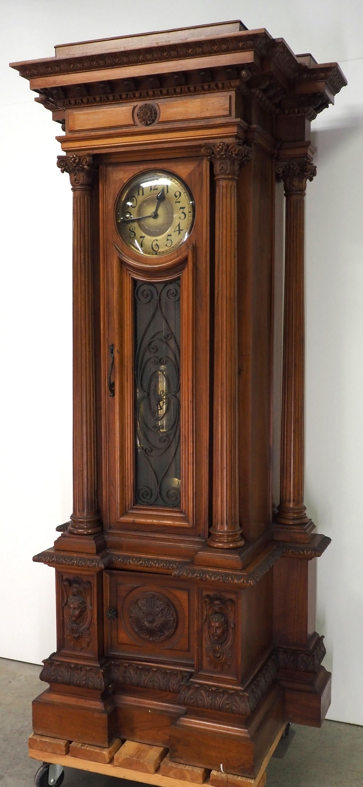 German Tall Case Grandfather Clock with Fluted Corinthian Columns: German Tall Case Grandfather Clock with Fluted Corinthian Columns, Elaborate Carvings and Brass Dial, with key Condition NOTICE! VERY IMPORTANT! Chupp Auctions is pleased to issue an opinion on any lo