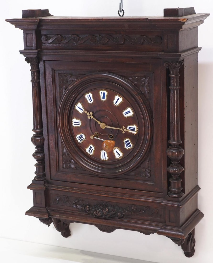 Carved Walnut English Wall Clock: Carved Walnut English Wall Clock with Enamel Roman Numerals and key Condition NOTICE! VERY IMPORTANT! Chupp Auctions is pleased to issue an opinion on any lot; the absence of a condition report does n