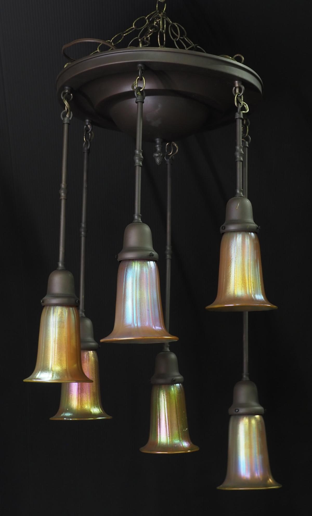 Super Arts & Craft Graduated Pendant Fixture with 6 Art Glass Shades: Super Arts & Craft Patinaed Brass Long Hanging Graduated Pendant Fixture with 6 Gold Aurene Art Glass Shades Condition NOTICE! VERY IMPORTANT! Chupp Auctions is pleased to issue an opinion on any 