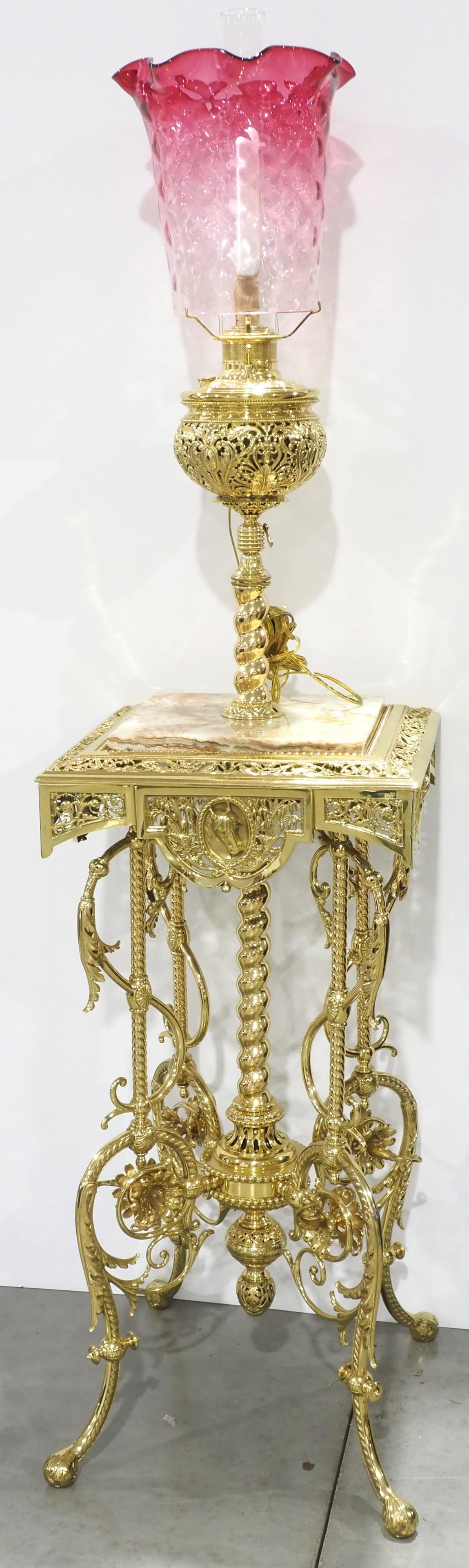 Elaborate Piano/Organ Floor Lamp with Marble Top: Elaborate Polished Brass Piano/Organ Floor Lamp with Marble Top, Horse Head and Hoofed Feet Embellishments and Ruffled, Quilted Pink Glass Shade Condition NOTICE! VERY IMPORTANT! Chupp Auctions is ple