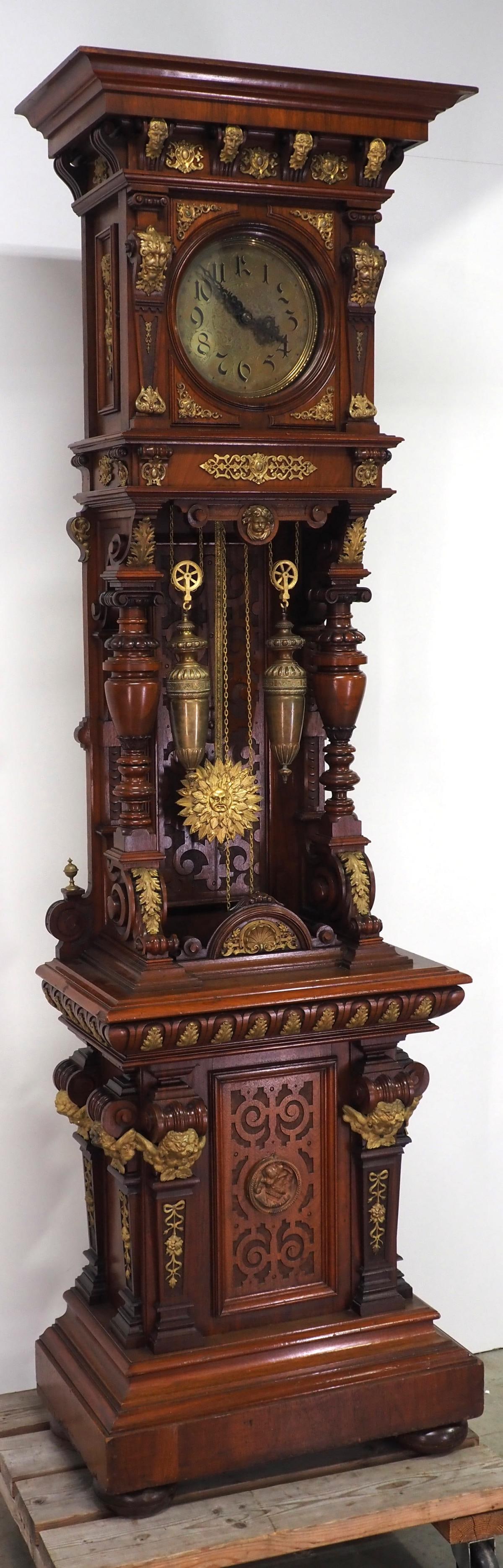 Exceptional Carved Mahogany German Hall Clock: Exceptional Carved Mahogany German Hall Clock by Lorenze Furtwangler & Sonne with Elaborate Gilt Bronze Mounts, Brass Dial with Floral Designs, Sunburst Face Pendulum and Matching Weights, Time &a