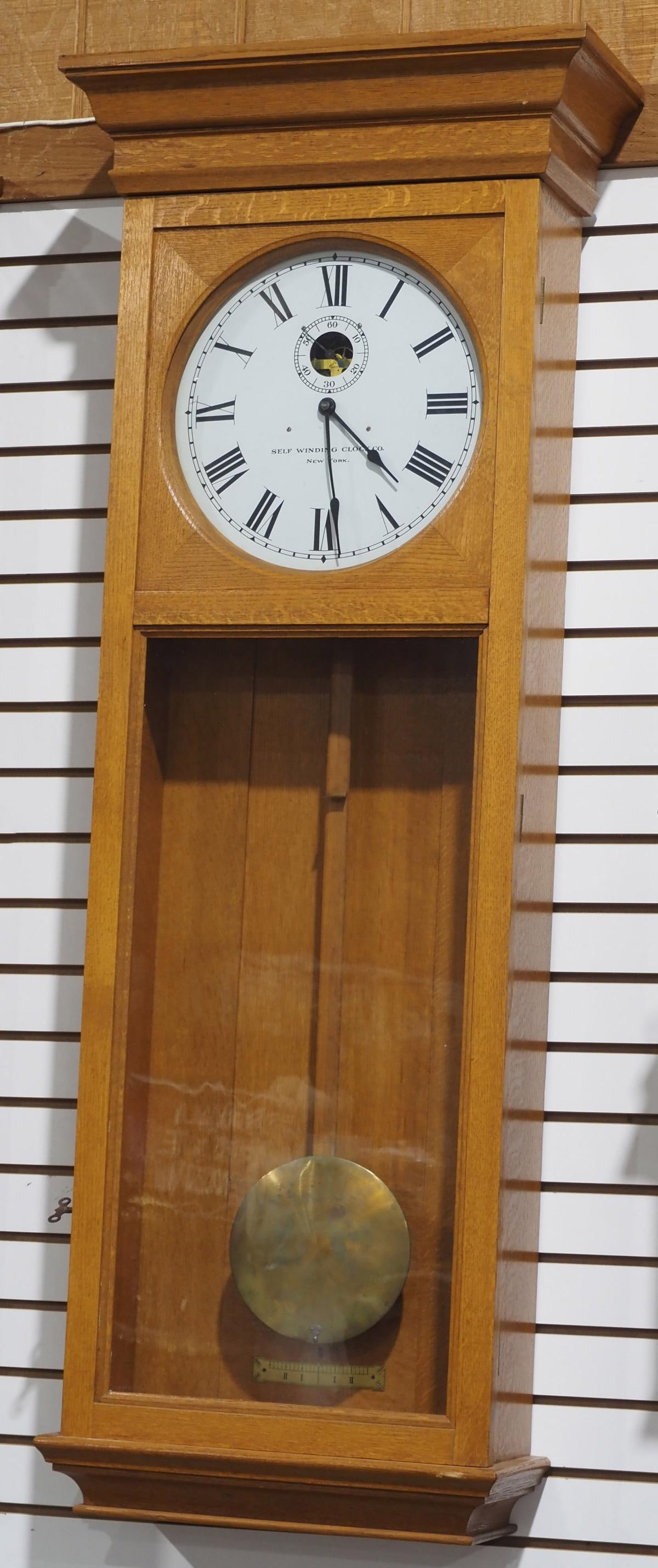 Self-Winding Clock Co. Oak Self-Winding Master Wall Clock: Self-Winding Clock Co., New York, Oak Self-Winding Master Wall Clock with Brass Pendulum Condition NOTICE! VERY IMPORTANT! Chupp Auctions is pleased to issue an opinion on any lot; the absence of a co