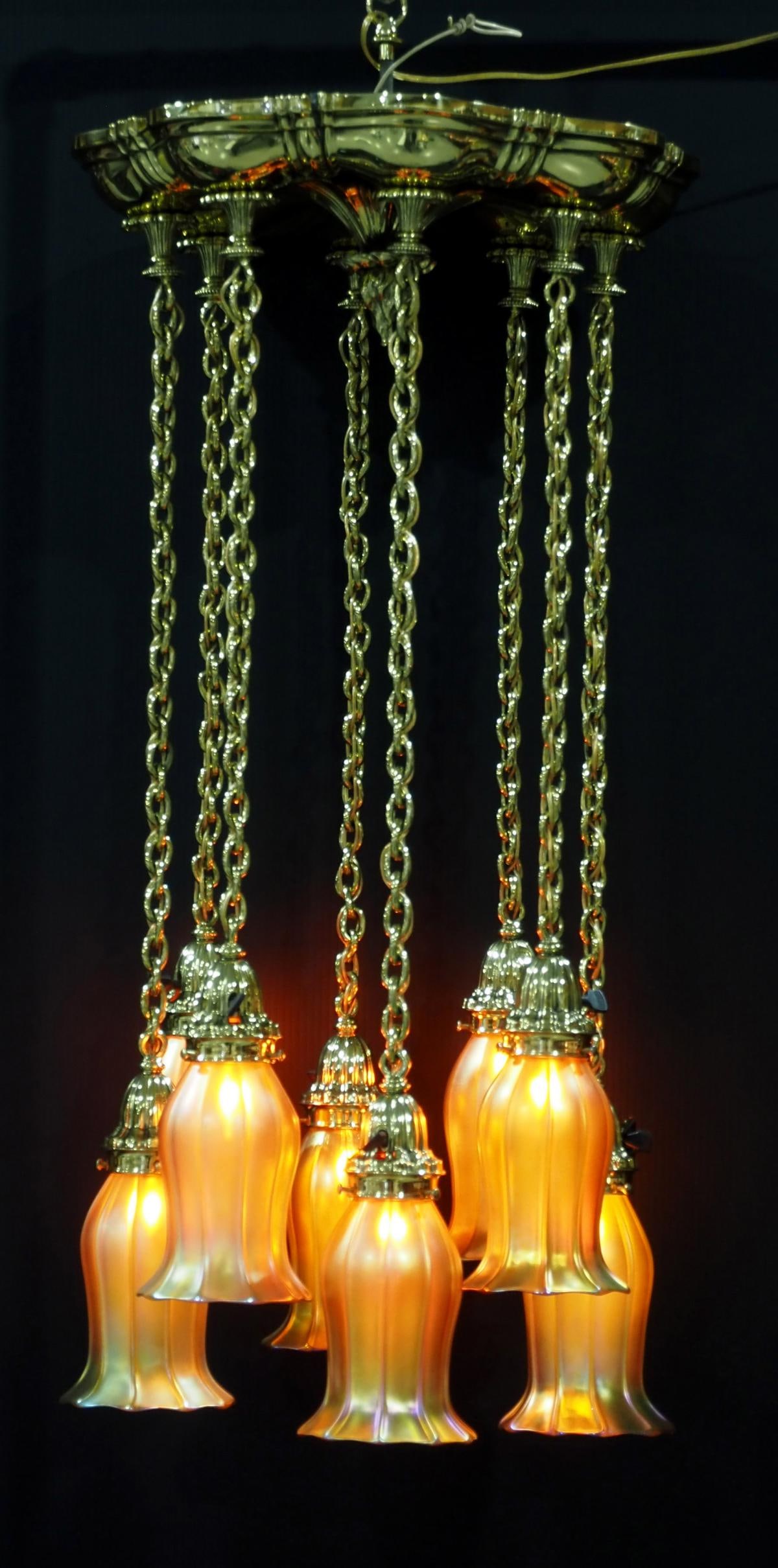 Arts & Crafts Brass Light Fixture with 8 Signed Quezal Shades: Arts & Crafts Brass Ceiling Mount Light Fixture with 8 Signed Quezal Gold Aurene Shades Condition NOTICE! VERY IMPORTANT! Chupp Auctions is pleased to issue an opinion on any lot; the absence of a con