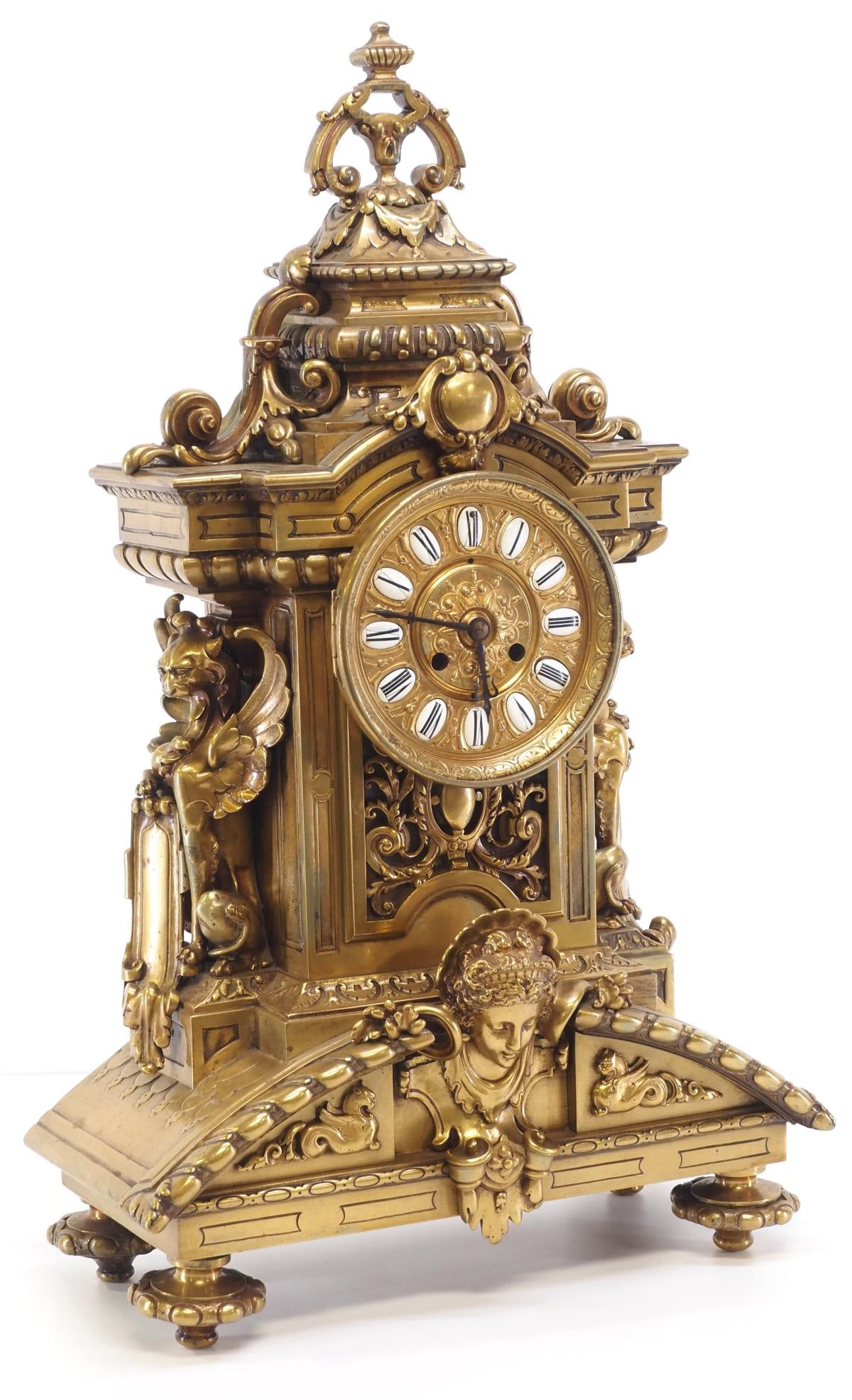 19th Century French Gilt Bronze Mantle Clock: 19th Century French Gilt Bronze Mantle Clock with Maiden Bust, Winged Griffins and Enameled Dial, works stamped J.E.D. 8768 Condition NOTICE! VERY IMPORTANT! Chupp Auctions is pleased to issue an opin