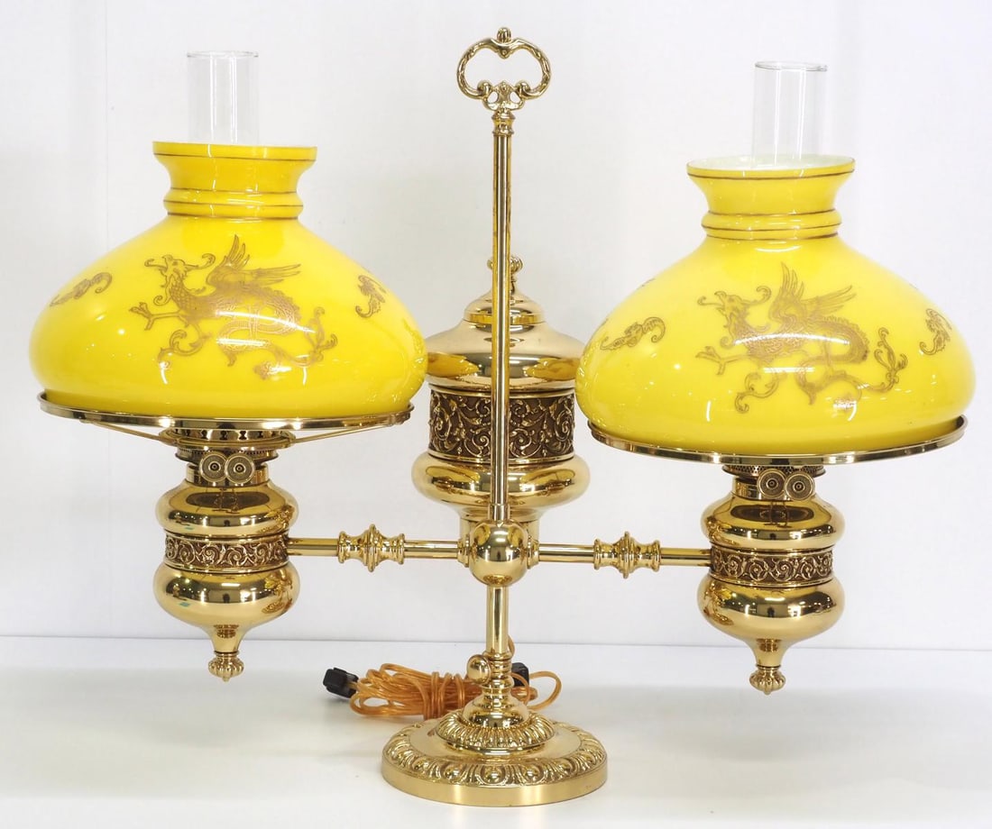 19th Century Double Brass Student Lamp with Cased Yellow Shades: 19th Century Double Brass Student Lamp with Cased Yellow Shades and Gold Dragon Overlay Condition NOTICE! VERY IMPORTANT! Chupp Auctions is pleased to issue an opinion on any lot; the absence of a con