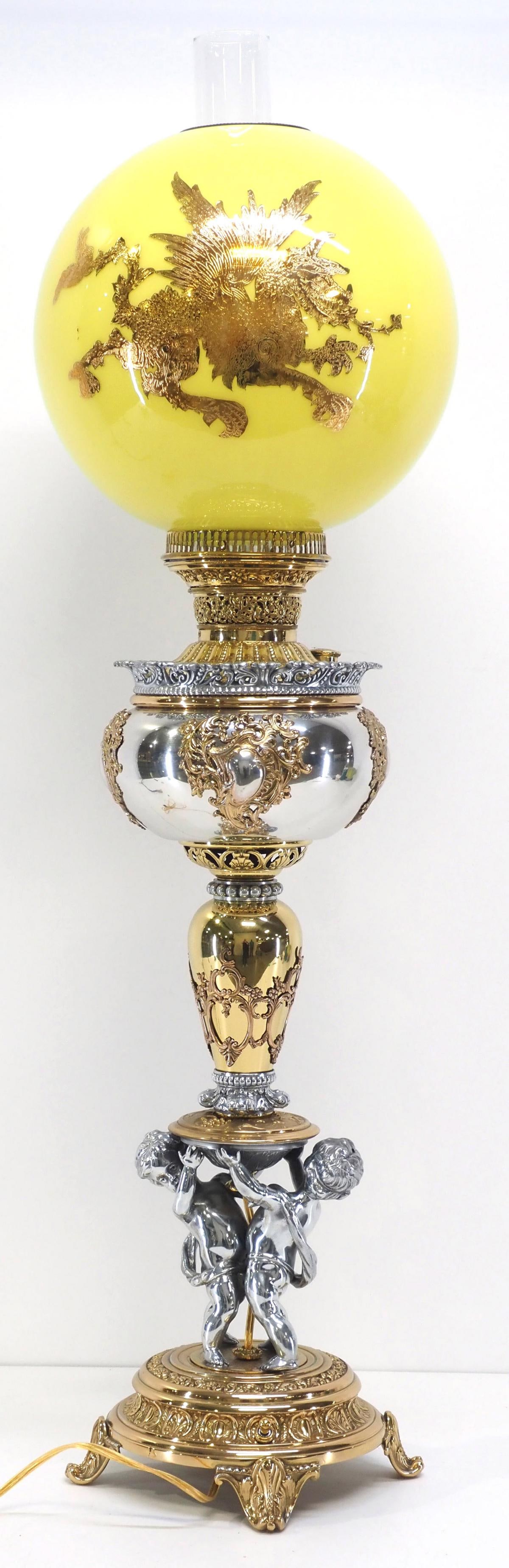 Victorian Banquet Lamp with Cherubs and Yellow Cased Ball Globe: Victorian Polished Nickel & Brass Banquet Lamp with Cherubs and Yellow Cased Ball Globe with Gold Overlay Dragon Condition NOTICE! VERY IMPORTANT! Chupp Auctions is pleased to issue an opinion on any 