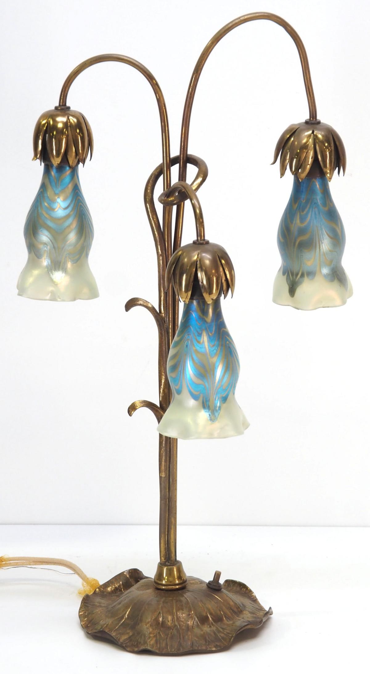 Tiffany-Style Brass Table Lamp with Tulip Gold Aurene Shades: Tiffany-Style Brass Table Lamp with Tulip Gold Aurene Shades Condition NOTICE! VERY IMPORTANT! Chupp Auctions is pleased to issue an opinion on any lot; the absence of a condition report does not indi