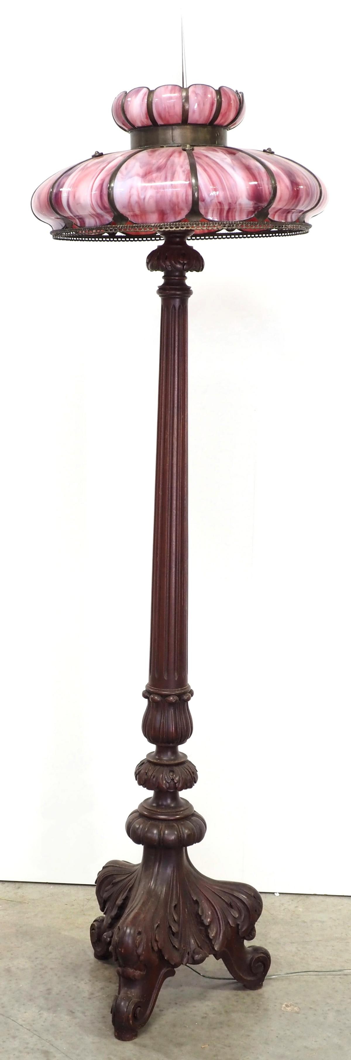 Mahogany Floor Lamp with Elaborate Carved Base and Pink Slag Glass Shade: Mahogany Floor Lamp with Elaborate Carved Base, Pink Curved Slag Glass Paneled Shade and Large Crystal Finial Condition NOTICE! VERY IMPORTANT! Chupp Auctions is pleased to issue an opinion on any lot