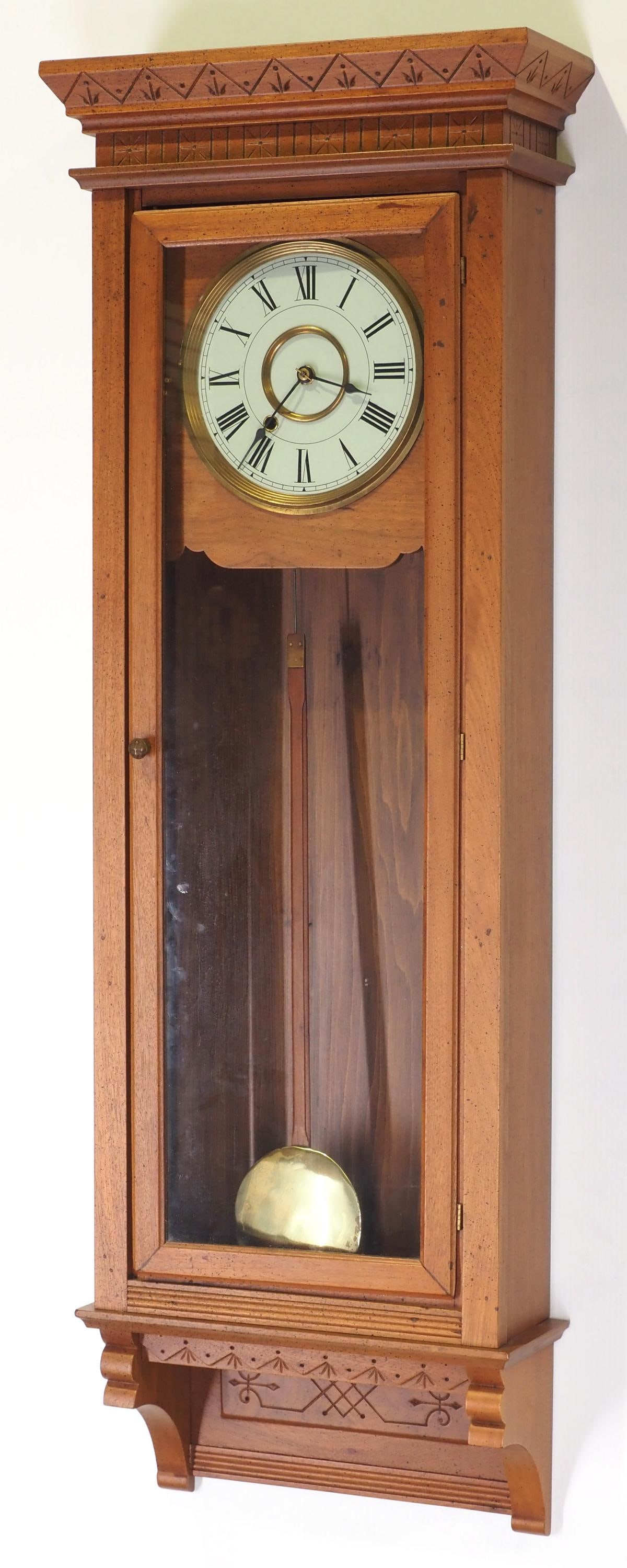 Pencil-Carved Wood-Cased Wall Regulator Clock: Pencil-Carved Wood-Cased Wall Regulator Clock with Brass Pendulum Condition NOTICE! VERY IMPORTANT! Chupp Auctions is pleased to issue an opinion on any lot; the absence of a condition report does not