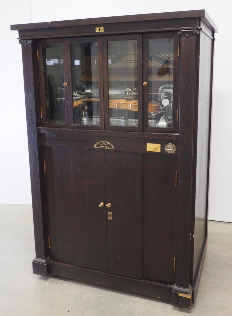 Coin-operated Mills Violano-Virtuoso Music Machine: Coin-operated Mills Violano-Virtuoso Music Machine. Only 4,000 to 5,000 of these music machines were made, this one made after 1912. It is a stunning piece of work featuring 1 interior light, a 4-pane