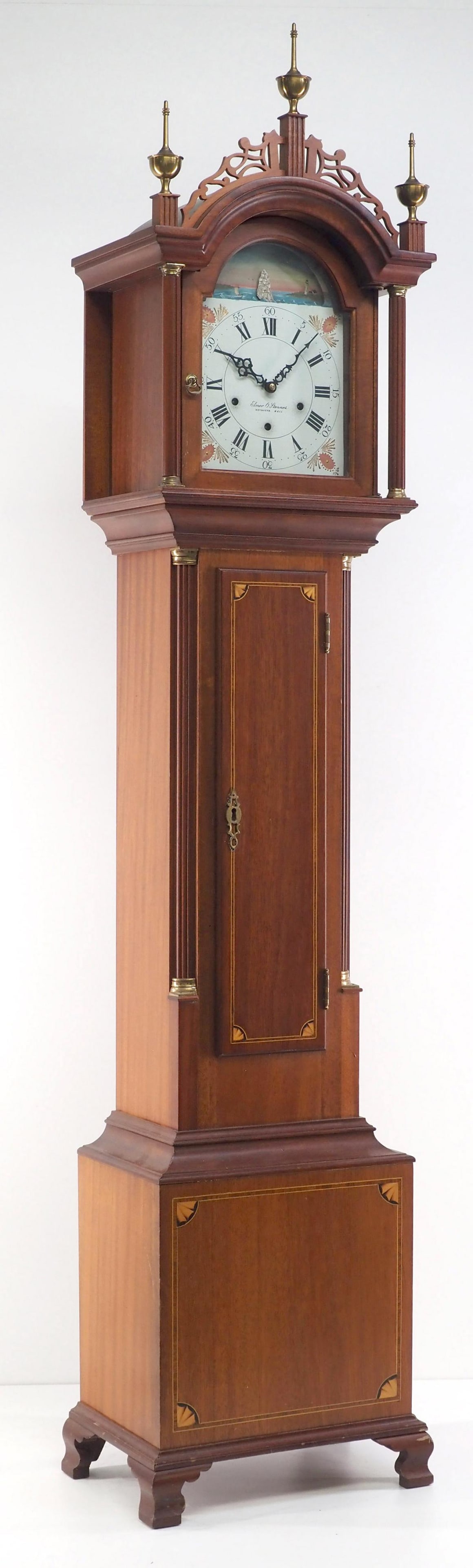 Elmer O. Stennes Dwarf Grandfather Clock: Elmer O. Stennes Dwarf Grandfather Clock with Painted Tin Dial, Animated Rocking Ship Arch Movement, Roxbury-style Inlaid Mahogany Case with Brass Finials and Accents Condition NOTICE! VERY IMPORTANT!