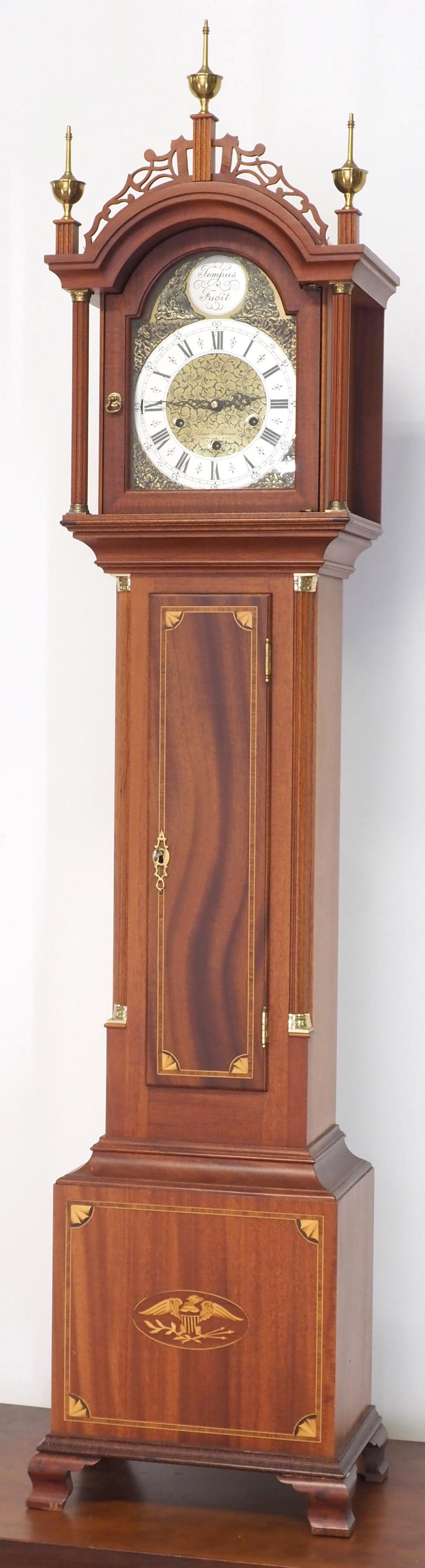 Elmer O. Stennes 'Temus Fugit' Dwarf Grandfather Clock: Elmer O. Stennes "Temus Fugit" Dwarf Grandfather Clock with Metal Dial, Mahogany Case Inlaid with Eagle and Shield, Brass Finials and Accents, Marked Inside Door and on Dial Condition NOTICE! VERY IMP