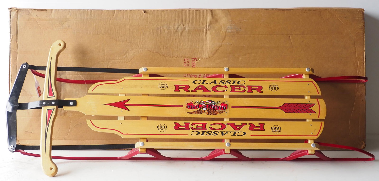 NOS Flexible Flyer Classic Racer child's sled: NOS Flexible Flyer Classic Racer child's sled with original cardboard box, 55"L - Excellent! * * NOT ELIGIBLE FOR IN-HOUSE SHIPPING. Please contact the auction house for transport options and
