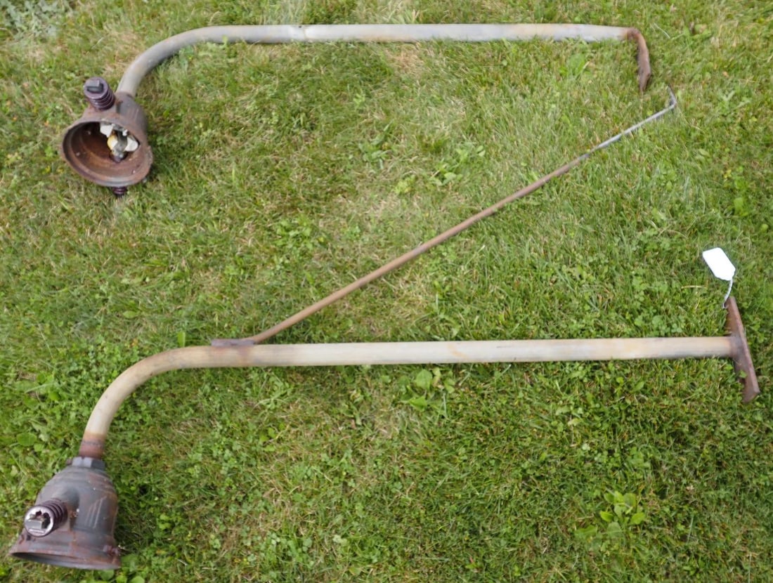Pair of Art Deco service station lights: Pair of Art Deco service station lights with insulators, approx. 54"L * * NOT ELIGIBLE FOR IN-HOUSE SHIPPING. Please contact the auction house for transport options and additional details. Items must