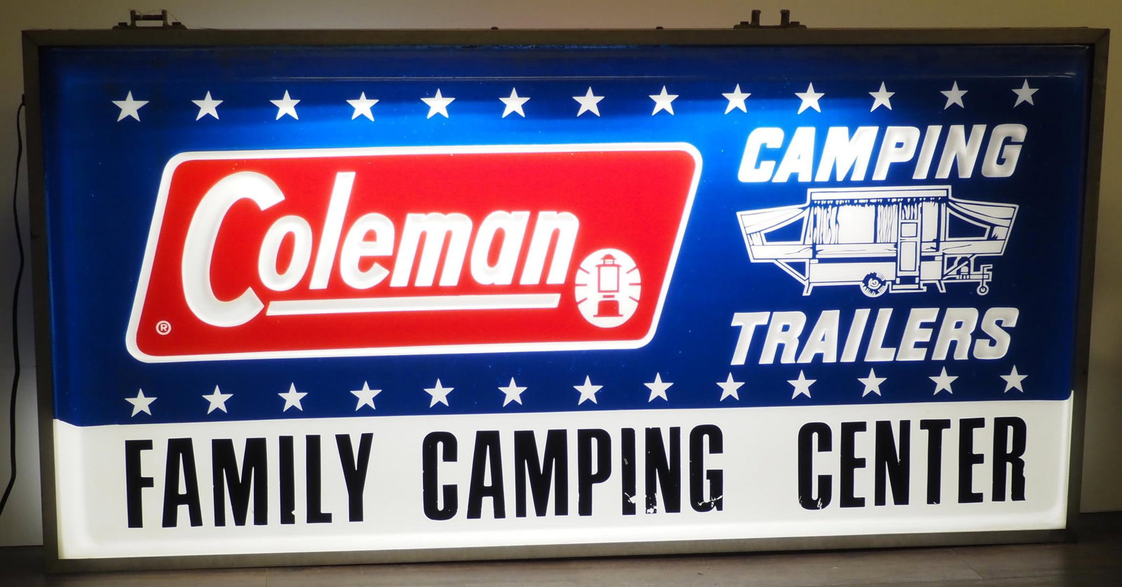 Coleman Camping Trailer lighted sign: 72.5"x36" metal & plastic Coleman Camping Trailer lighted sign - Good, works * * NOT ELIGIBLE FOR IN-HOUSE SHIPPING. Please contact the auction house for transport options and additional details.