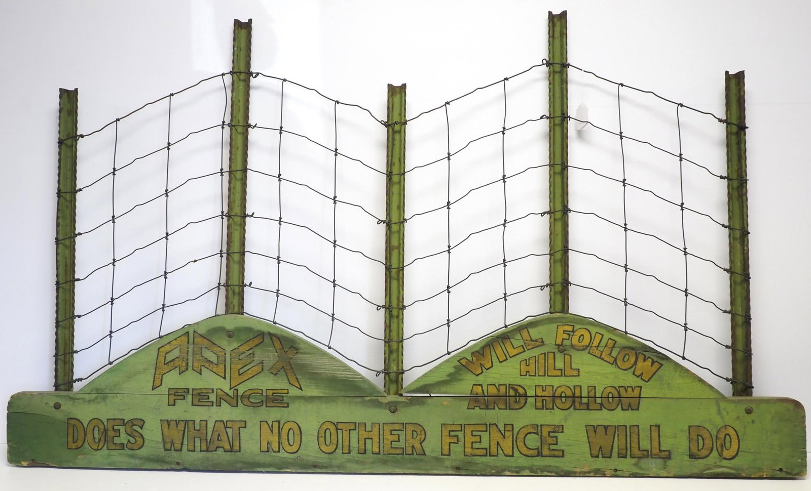 Apex Fence store display: Apex Fence store display with wire fence and steel posts on wood base, great stenciling! 80"x47" * * NOT ELIGIBLE FOR IN-HOUSE SHIPPING. Please contact the auction house for transport options and