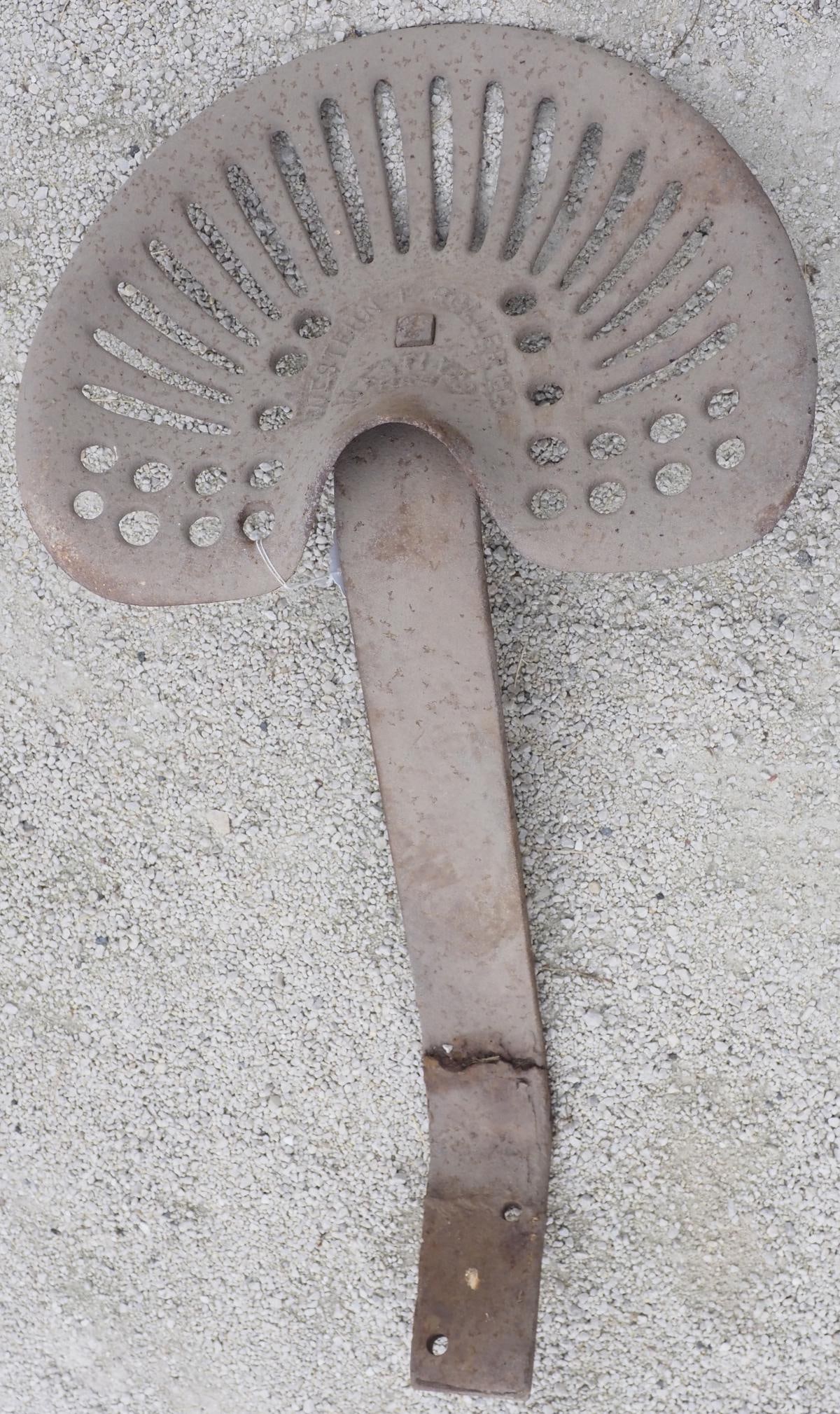 Western L Roller Co. cast iron seat: Western L Roller Co., Hastings, Neb cast iron seat with mount