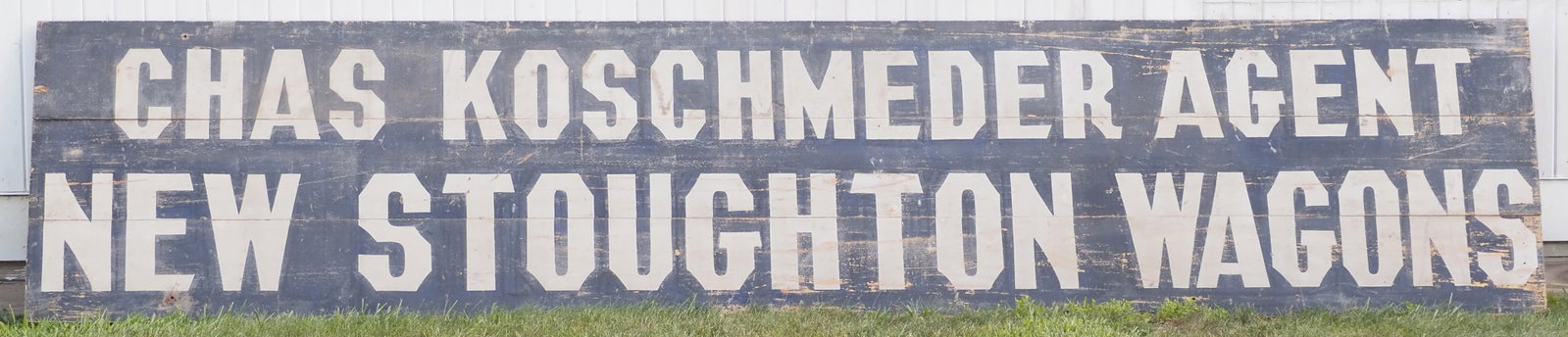 New Stoughton Wagons dealer sign: 165"x34" 1-sided wood & sandstone New Stoughton Wagons, Chas Koschmeder Agent dealer sign * * NOT ELIGIBLE FOR IN-HOUSE SHIPPING. Please contact the auction house for transport options and additional