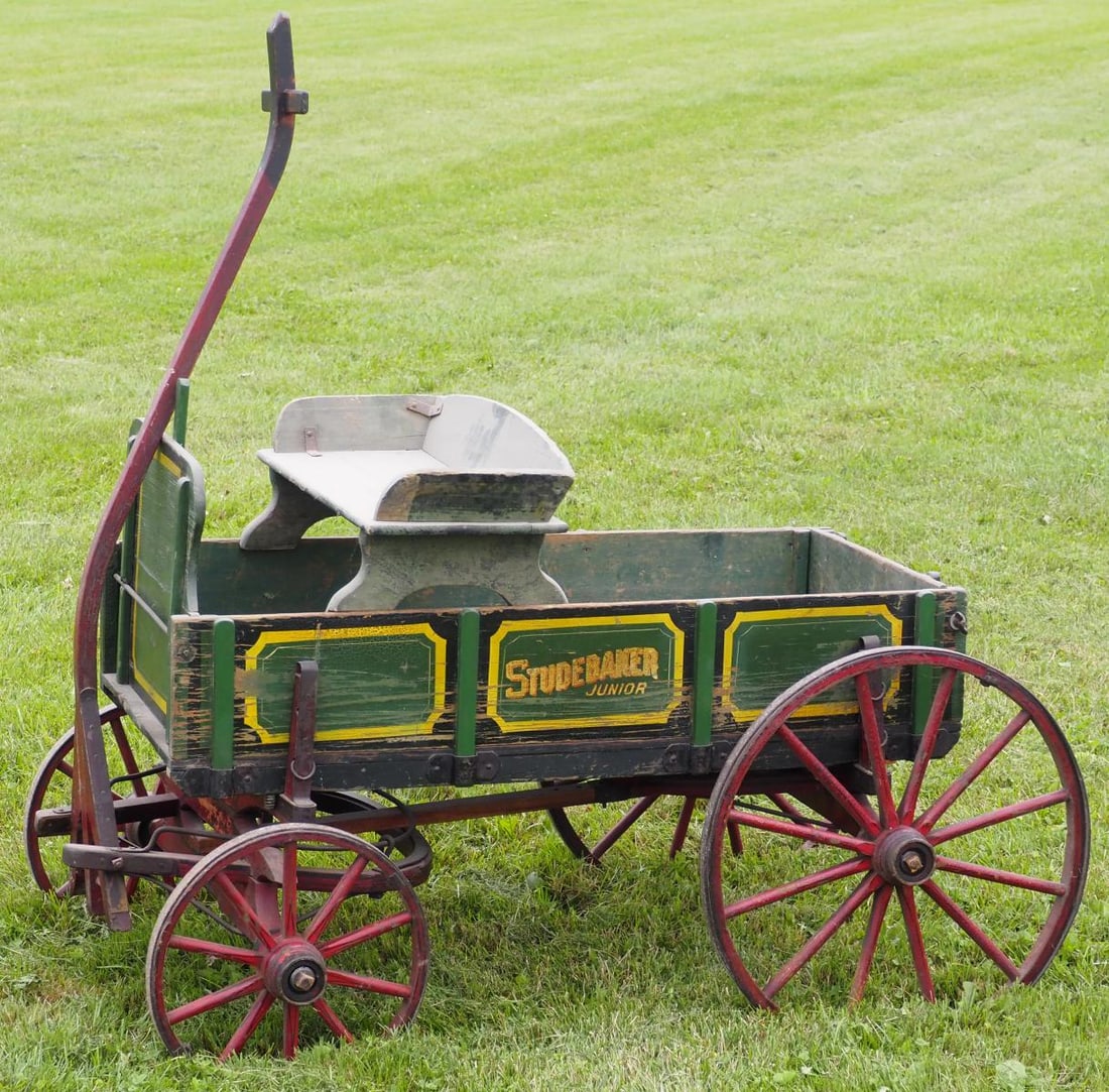 Studebaker Jr goat wagon: Studebaker Jr goat wagon with Studebaker seat, pull handle, very good original paint and stenciling * * NOT ELIGIBLE FOR IN-HOUSE SHIPPING. Please contact the auction house for transport options and