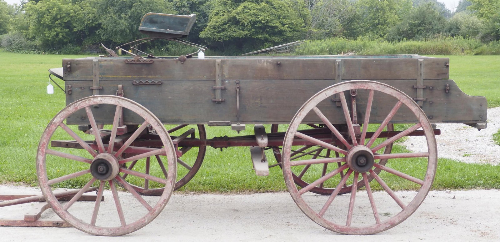 Brown box wagon: Brown box wagon with hand brake and shafts, 132"L x 72"W x 51"H (seat sells separate) - Fair with faint stenciling * * NOT ELIGIBLE FOR IN-HOUSE SHIPPING. Please contact the auction house for