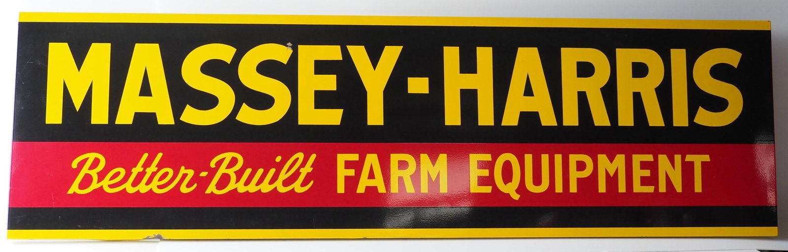Massey-Harris Better Built Farm Equipment sign: 8'x28" SSP self-framed Massey-Harris Better Built Farm Equipment sign - Very Good with a couple small chips * * NOT ELIGIBLE FOR IN-HOUSE SHIPPING. Please contact the auction house for transport