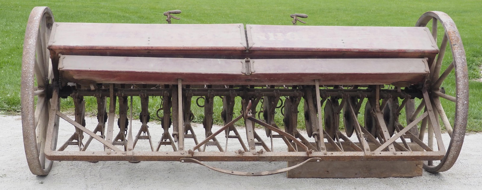 John Deere Van Brunt grain drill: John Deere Van Brunt grain drill with wooden wheels, wheels 45"dia., 114"W overall * * NOT ELIGIBLE FOR IN-HOUSE SHIPPING. Please contact the auction house for transport options and additional