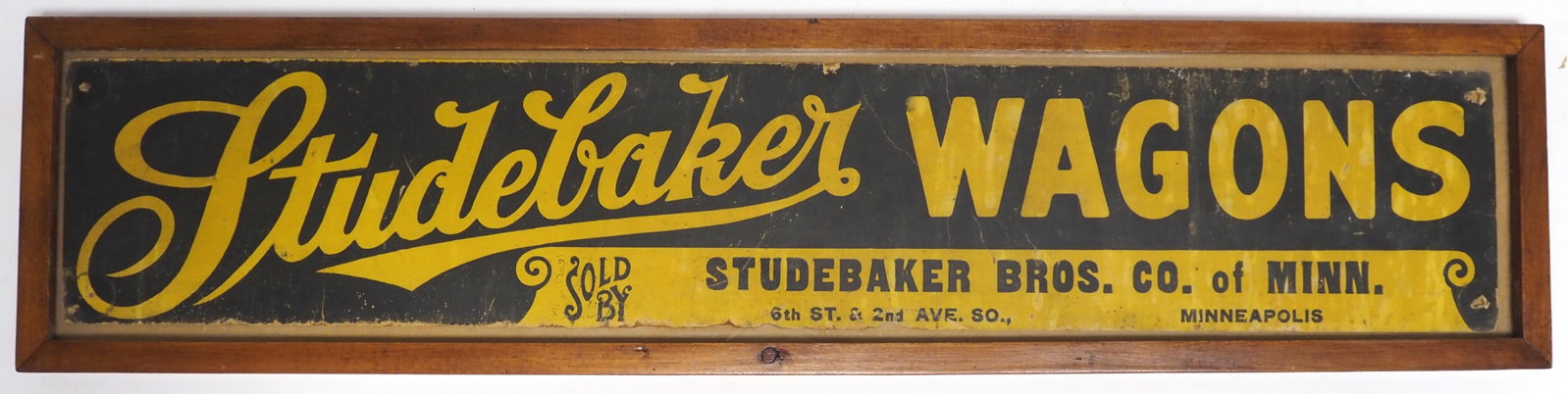 Framed cardboard Studebaker Wagons sign: Framed cardboard Studebaker Wagons sign, frame measures 30"x5.5" - Fair Condition Fair