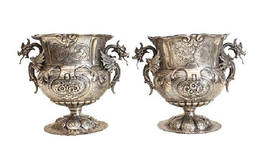 Pair Continental 800 Silver Wine Coolers: An .800 solid silver pair of wine coolers, hand engraved scrolls with floral repousse, the handles taking the form of dragons or winged serpents. Late 19th or Early 20th Century. Weight: 54.67ozt. Mea