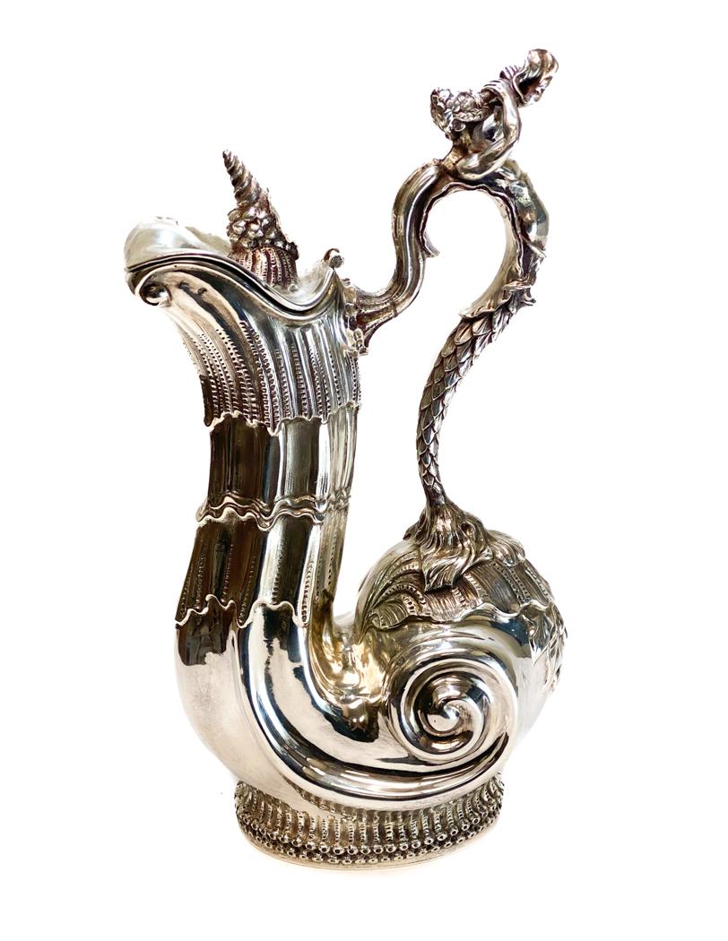 Puiforcat Sterling Silver Ewer.: A fine Emile Puiforcat Sterling Silver wine jug. A figural merman forming the handle blowing a horn with a seashell horn to the lid. Hand chased leaf accents to the handle. Finely hand chased and with