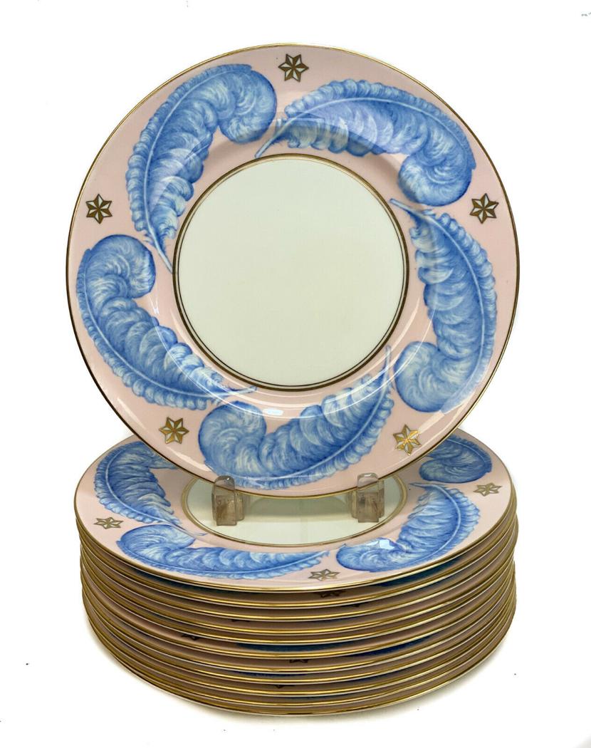 12 George Jones Crescent Porcelain Dinner Plates, c1930: 12 George Jones & Sons Crescent porcelain dinner plates, circa 1910 . A blush pink ground to the rims with blue feathers and nautical star accents. George Jones mark to the underside. Weight Approx., 