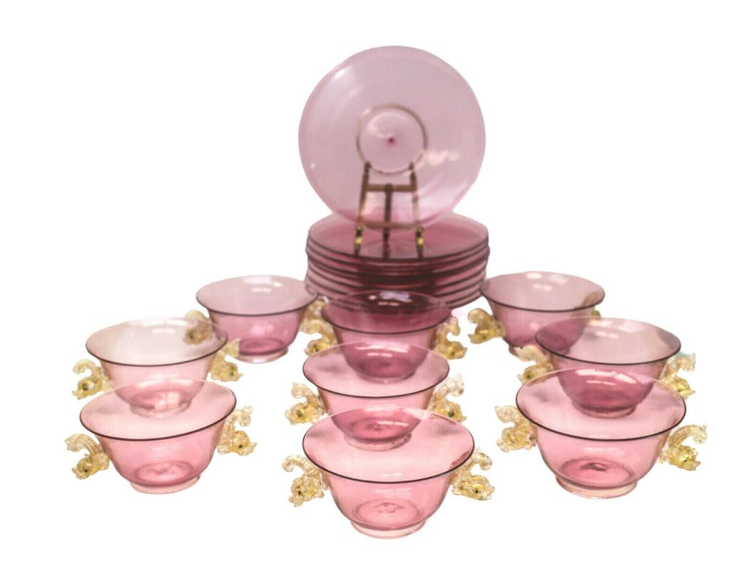 9 Salviati Cranberry Art Glass Bowls & Underplates: 9 Salviati Venetian art glass gold fleck cranberry bowls and underplates, circa 1960. Figural gold fleck dolphin figures to the handles. Weight Approx., 5 lbs Measures Approx., bowl: 6 inches x 4.5 in