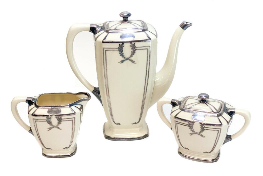 Lenox Porcelain Art Deco Silver Overlay Teaset: Lenox porcelain Art Deco silver overlay teaset, circa 1915. Laurel leaf designs throughout with an open monogram to towards the top rim. Marked Lenox to the underside. Weight Approx., 2 lbs Measures A