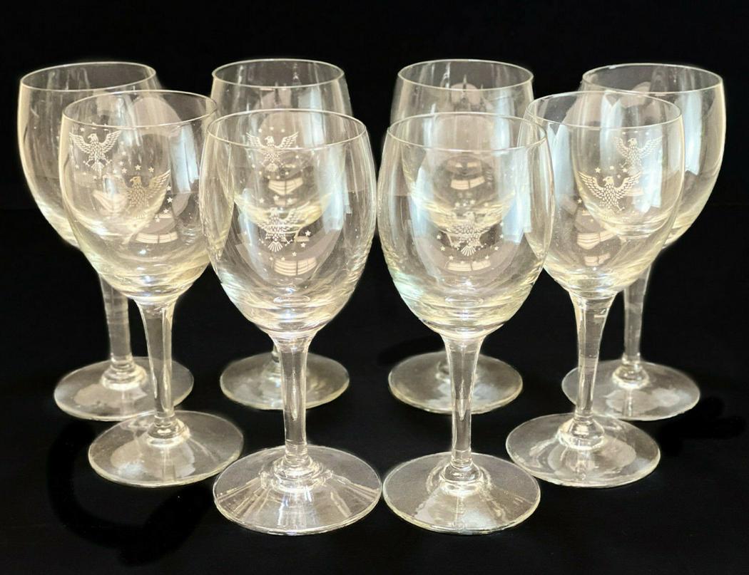 8 Pan Am 1st Glass Wine Goblets, Eagle Armorial: 8 Pan Am 1st Class cut glass wine goblets. An acid etched eagle armorial to the center with 13 stars around. Unmarked. Weight Approx., 3 lbs Measures Approx., 2.75 inches diameter x 6 inches Domestic 