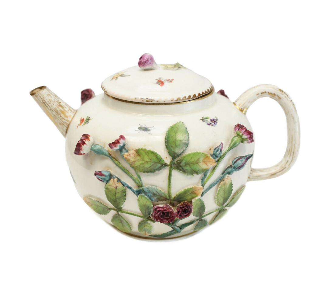 Rare Derby Blind Earl Pattern Teapot, Worcester Chelsea: An outstanding and rare blind earl pattern teapot, circa 1780. Most likely Derby but certainly English. Molded in relief with rosebuds and painted with scattered flowers, leaves and insects . The spou