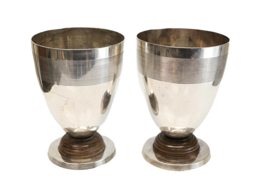2 Christofle Silverplate Wood Footed Beakers, c1920: 2 Christofle silverplate and wood large footed beakers, circa 1920. Hand chased circular bands towards the rim and to the base. Wood to the stem. Christofle mark to the underside base. Weight: 4 lbs M