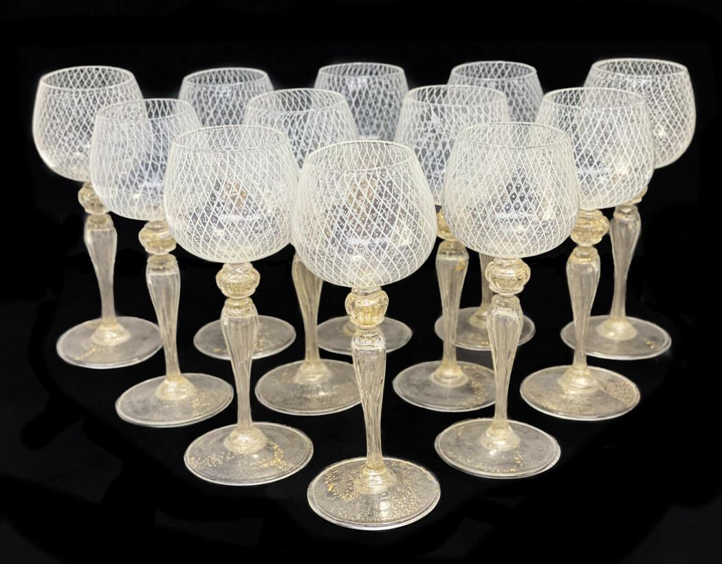 12 Venetian White Latticino Striped Sherry Wine Goblets: 12 Venetian white latticino striped sherry wine goblets, circa 1960. White latticino stripes to the bowls of the goblets. Gold fleck to the bulbous stems and bases. **At the time of this listing there