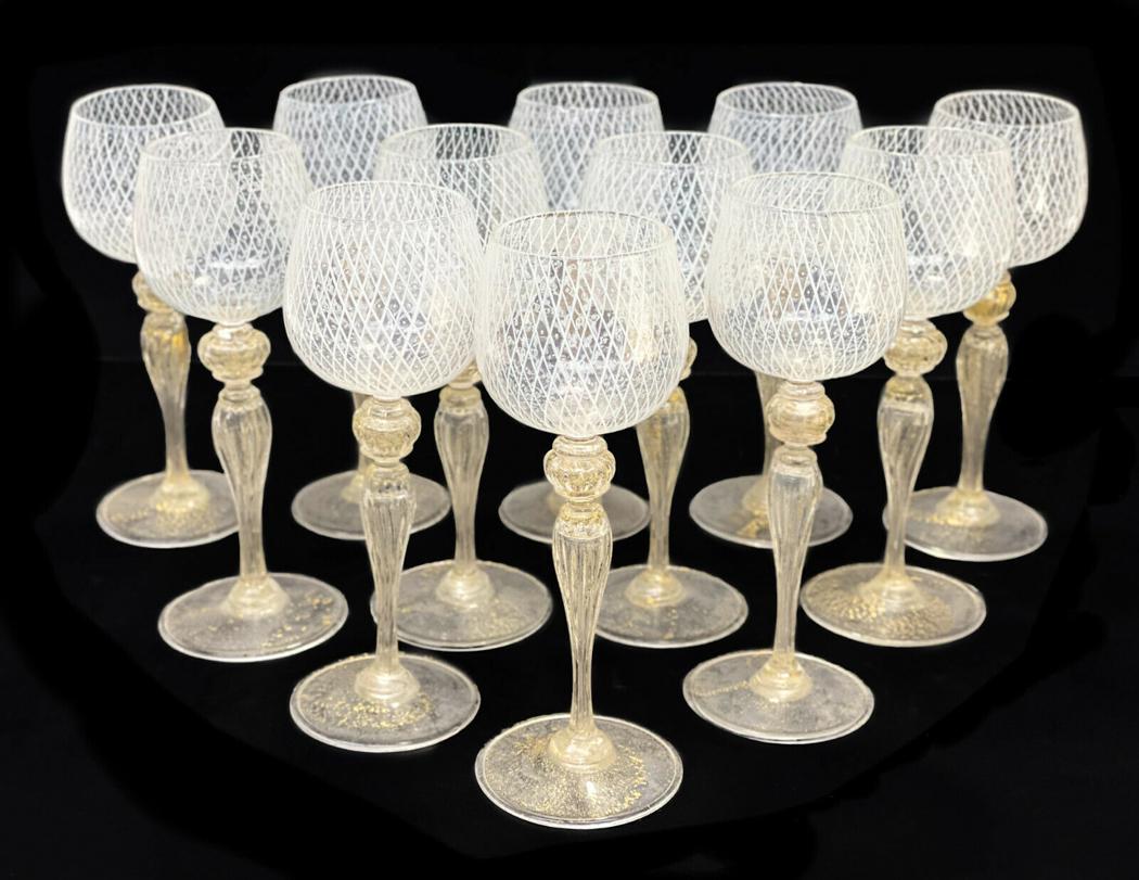 12 Venetian White Latticino Striped Wine Goblets: 12 Venetian white latticino striped wine goblets, circa 1960. White latticino stripes to the bowls of the goblets. Gold fleck to the bulbous stems and bases. **At the time of this listing there are ot