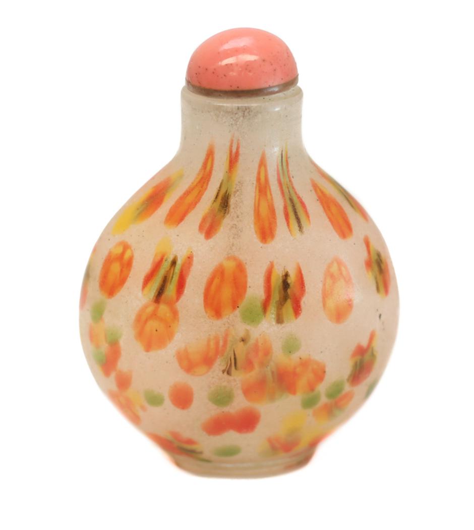 Chinese Glass Snuff Bottle. Mottled Bubbles: Chinese Glass Snuff Bottle. Mottled bubbles with green, yellow, and orange burst throughout. A coral stone stopper. Pre 1920. Weight Approx., 66.4 grams Measures Approx., 2.75 inches x 2 inches