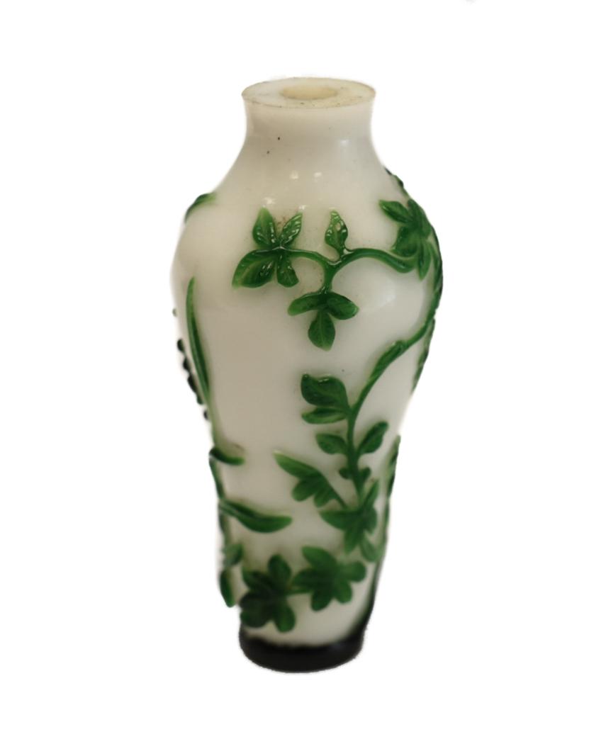 Chinese Peking Glass Green to White Snuff Bottle: Chinese Peking Glass Green to White Snuff Bottle. Vines and a beetle. Pre 1920. Weight Approx., 42.3 grams Measures Approx., 3 inches tall x 1.3 inches wide