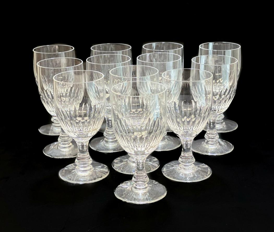 12 Baccarat Cut Glass Sherry Wine Goblets in Odeon: 12 Baccarat France cut glass sherry wine goblets in Odeon. Thumbprint designs to the lower half of the bowl. Acid etched Baccarat mark to the underside. Weight Approx., 8 lbs Measures Approx., 2.5 inc