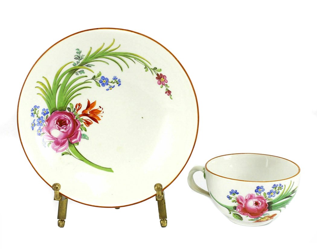 Meissen Porcelain Cup and Saucer: Porcelain Meissen cup & Saucer, c1800 Beautiful Delicately Hand Painted Multicolor Floral Design w / Burnt Orange Rims. Marked for Meissen, marcolini period. Weight 9oz. Measures approx., Cup 3 inches
