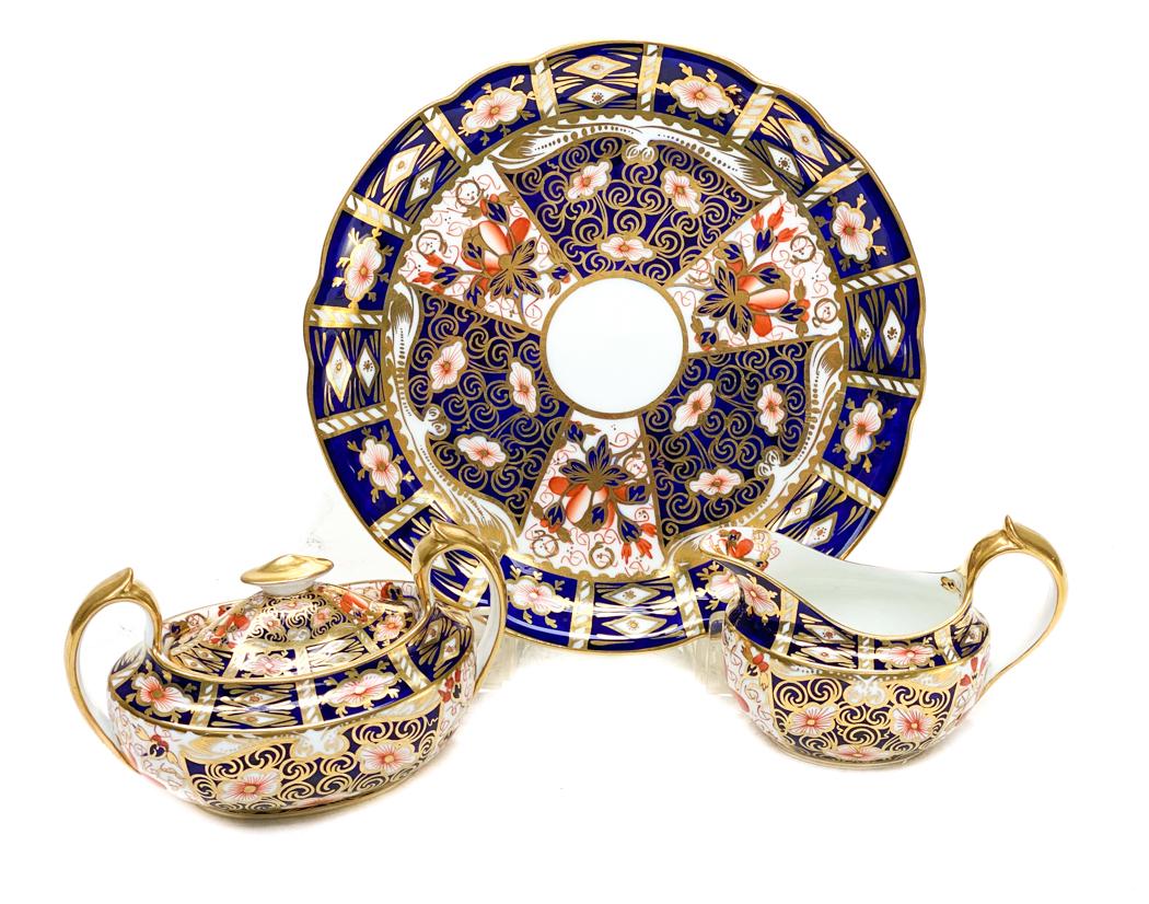 Royal Crown Derby Sugar and Creamer in Traditional: Royal Crown Derby Sugar and Creamer in Traditional Imari #2451. Blue panels, gold accents, and rust flowers throughout. Royal Crown Derby mark to the underside. Measures Approx., Plate: 8.5 inches / S
