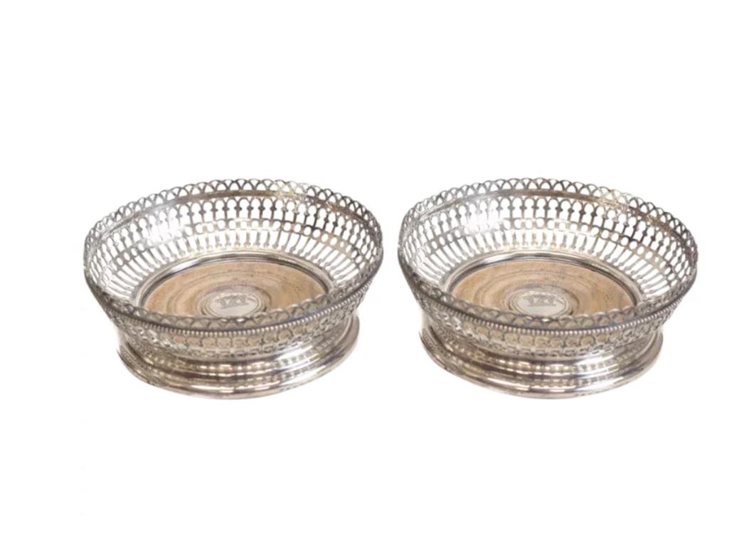 Pair of Elkington Silver Plate Pierced Wine Coasters: Pair of Elkington silver plate wine coasters, 19th Century. Pierced designs throughout the wine coasters with a hand chased bird image to the center. Weight Approx., 1.25 lbs Measures Approx., 6 inche